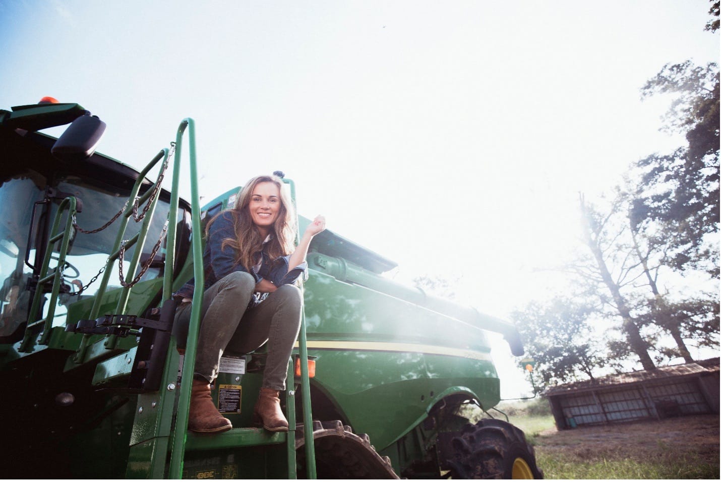 A 4 Sisters Rice farmer sitting on a green combine harvester on the family rice farm in Mer Rouge, Louisiana