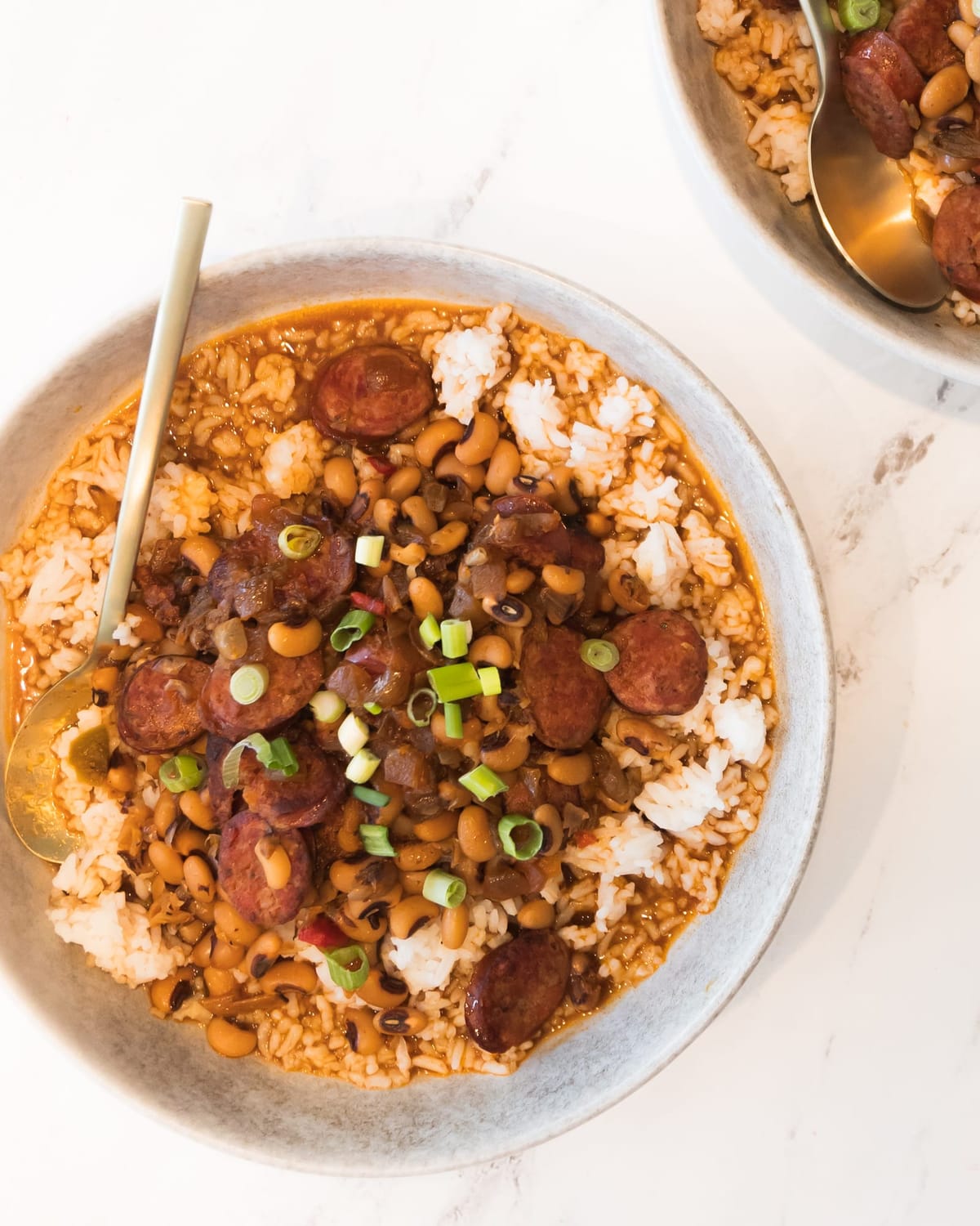 Hearty bowl of beans, sliced sausage, and rice